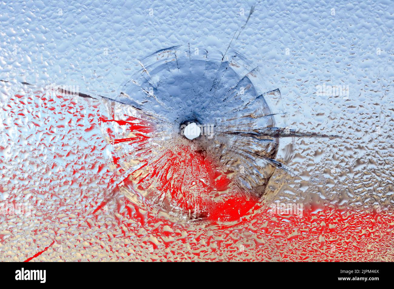 Bullet hole in broken glass and blood Stock Photo