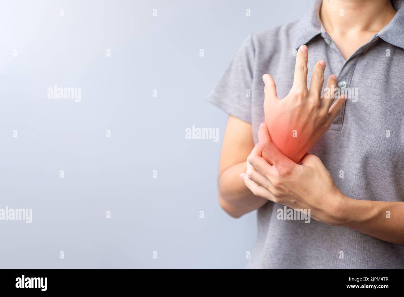 woman holding her wrist pain because using smartphone or computer long time. De Quervain s