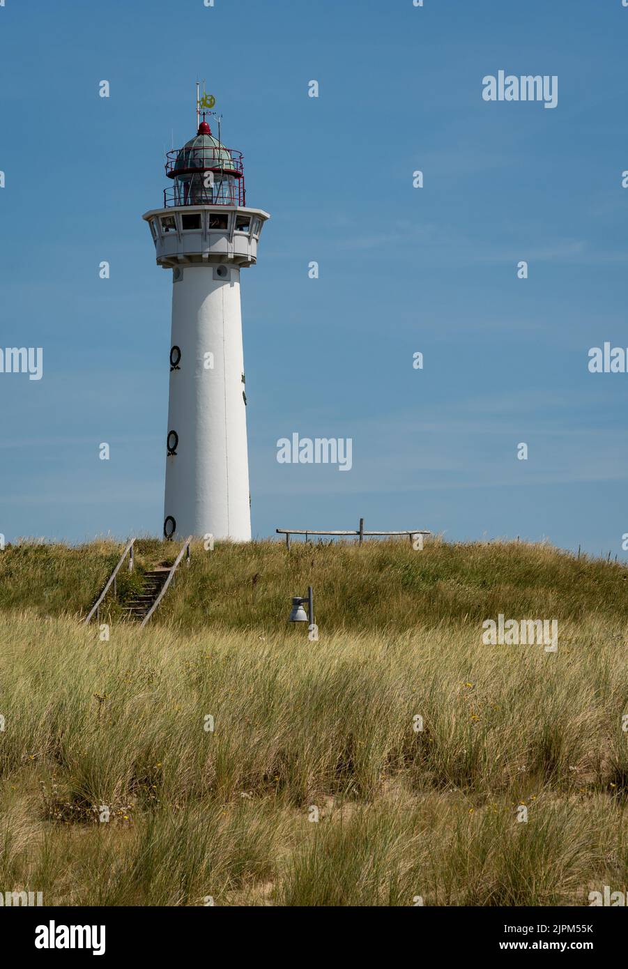 Vertical shot of white lighthouse in dutch coastal village Egmond aan ...