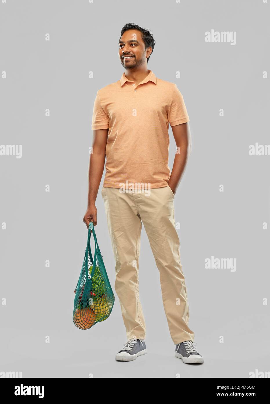 happy indian man with food in reusable net tote Stock Photo