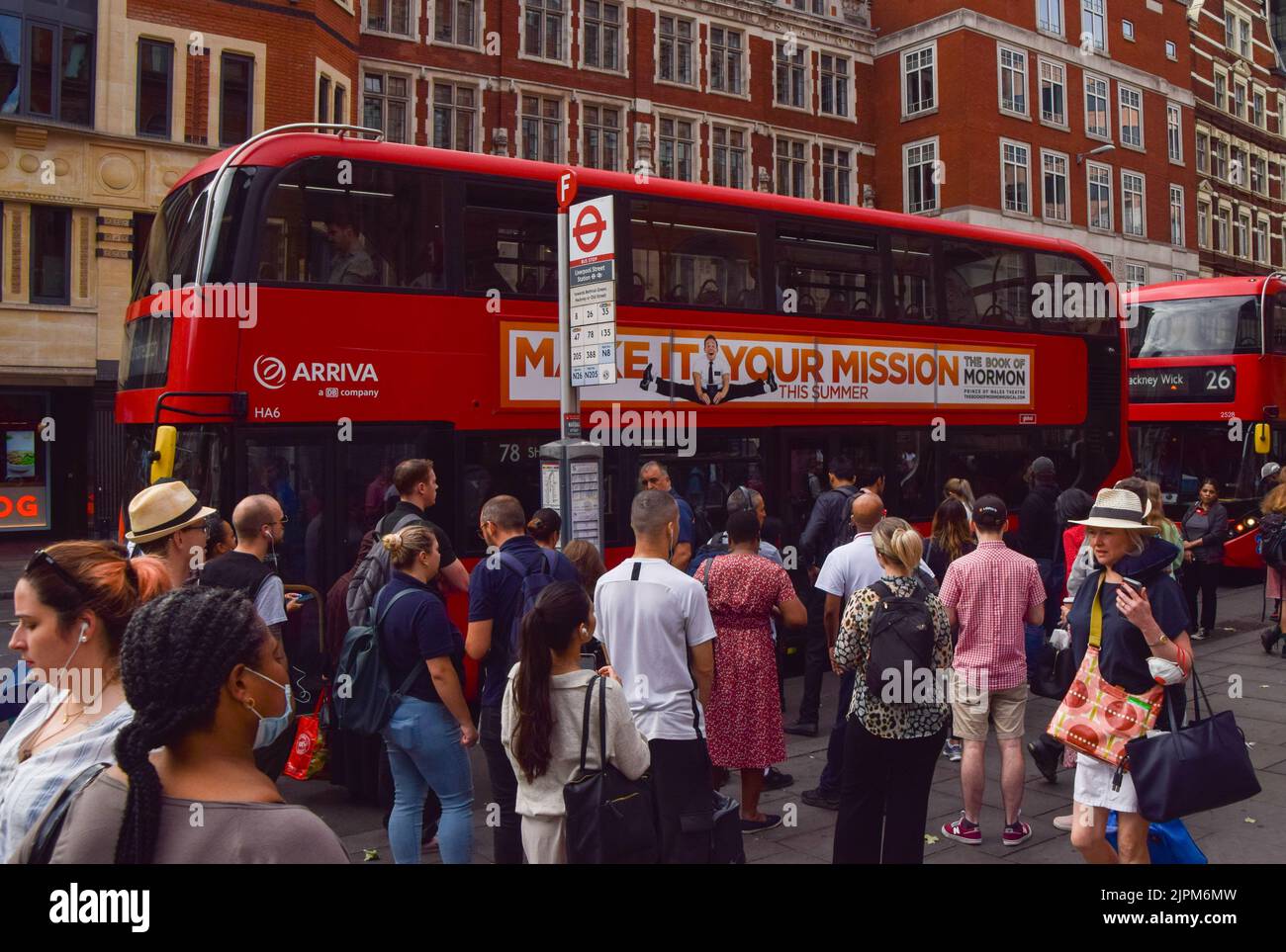 London, UK. 19th Aug, 2022. Commuters wait for buses outside Liverpool