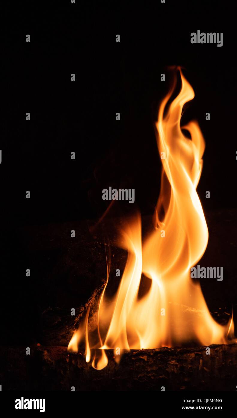 Fire flame on a dark background. Yellow tongues of fire in the
