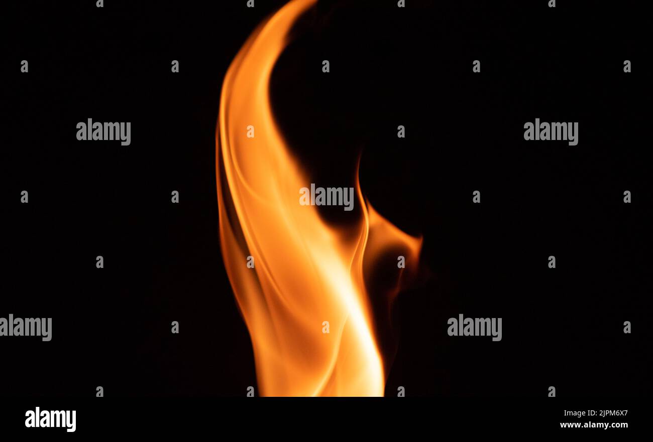 Fire flame on a dark background. Yellow tongues of fire in the