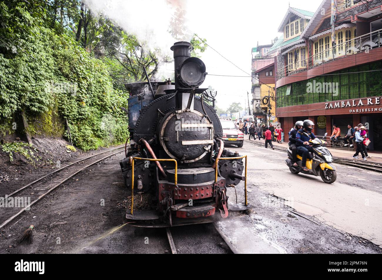 The Darjeeling Himalayan Railway, a UNESCO World Heritage Site,  also known as the DHR or the Toy Train, is a 610 mm gauge railway that runs between New Jalpaiguri and Darjeeling in the Indian state of West Bengal. It climbs from about 100 m above sea level at New Jalpaiguri to about 2,200 m (7,200 ft) at Darjeeling, using six zig zags and five loops to gain altitude. Six diesel locomotives handle most of the scheduled service, with daily tourist trains from Darjeeling to Ghum – India's highest railway station – and the steam-hauled Red Panda service from Darjeeling to Kurseong. Stock Photo