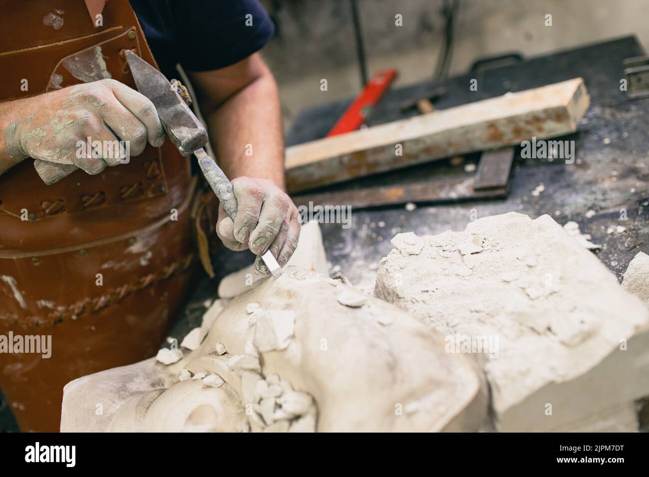 Man sculptor creates sculpt bust gypsum human woman sculpture with