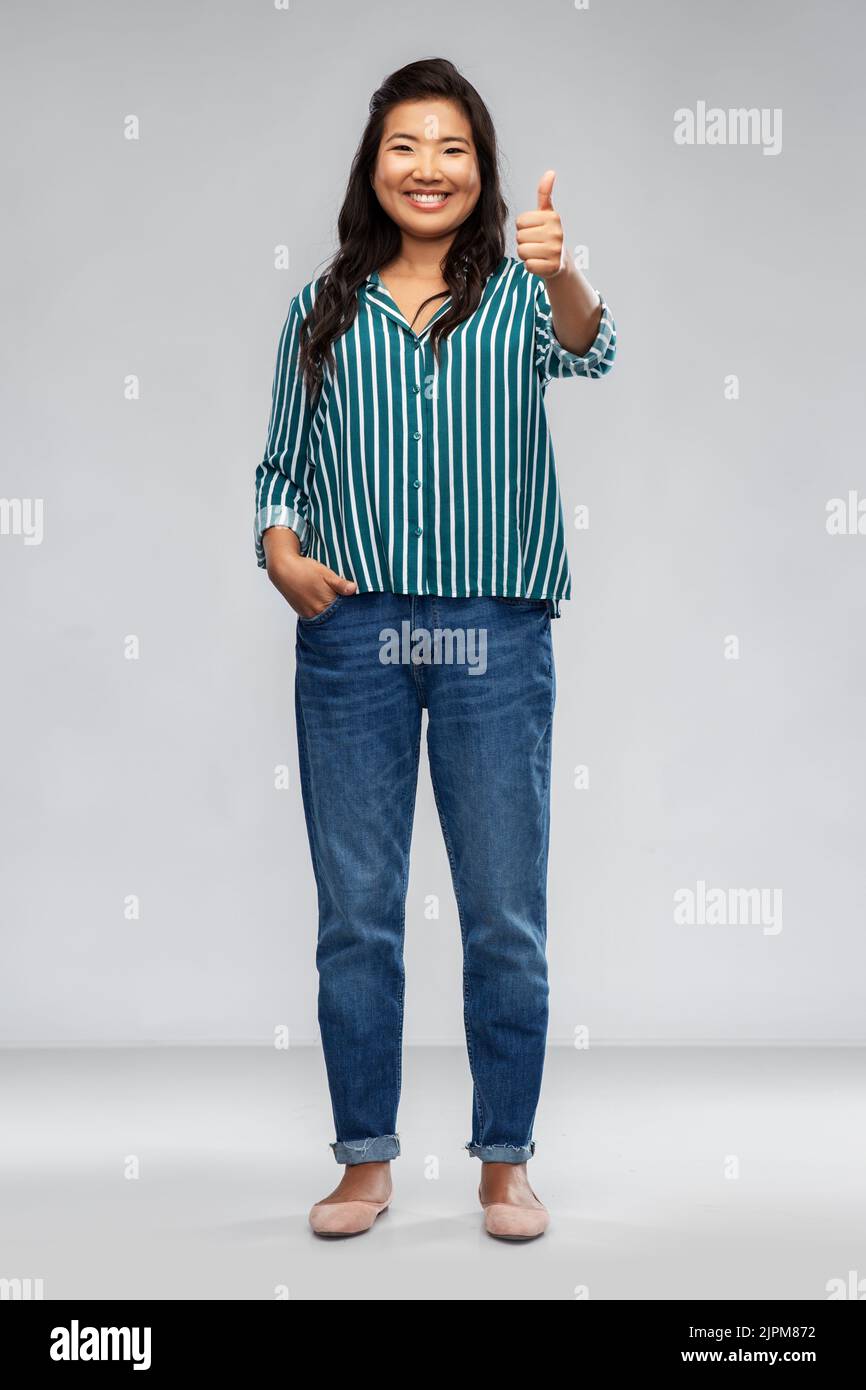 Smiling asian woman showing hi-res stock photography and images - Alamy
