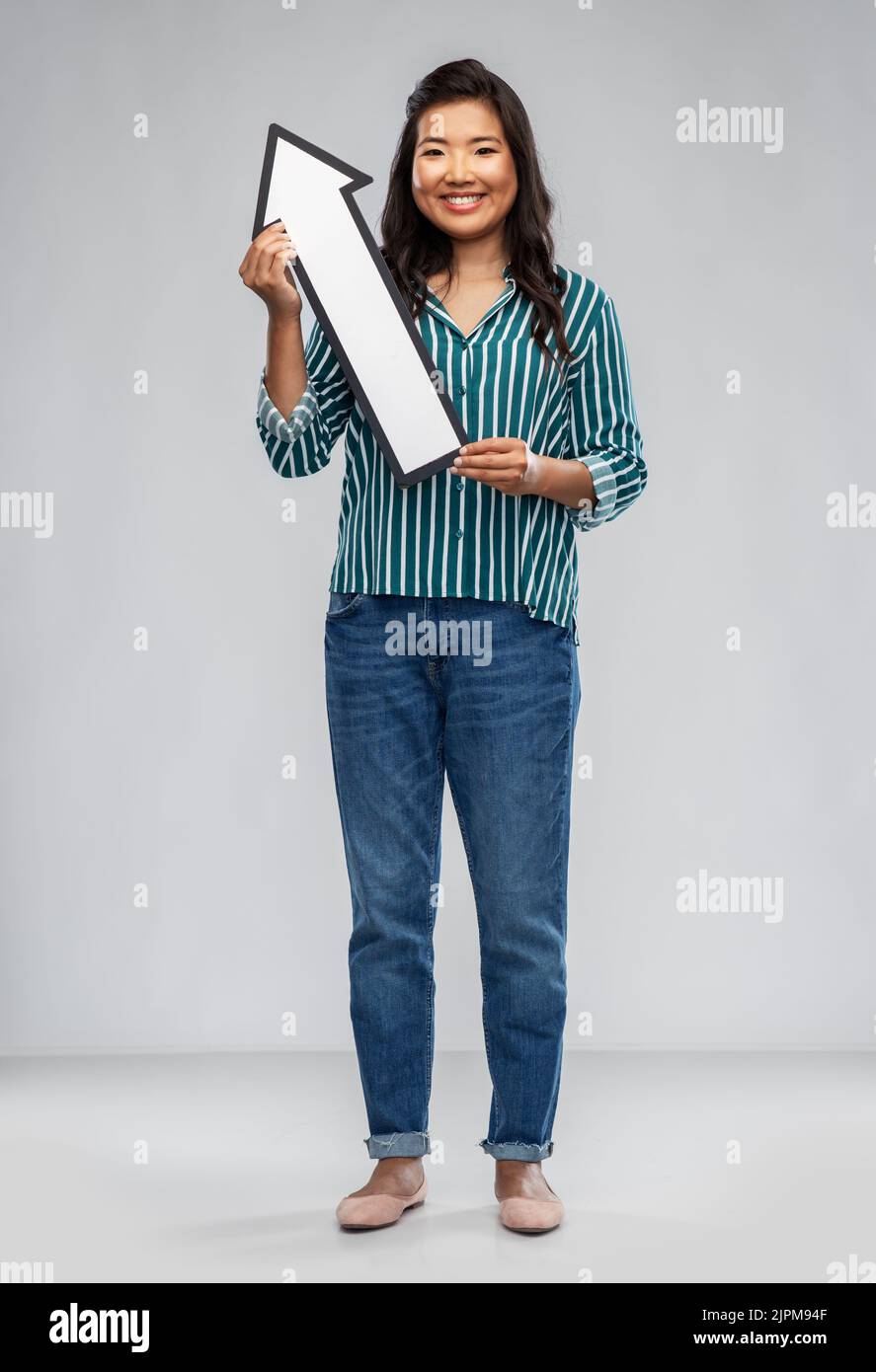happy smiling asian woman with arrow pointing up Stock Photo - Alamy