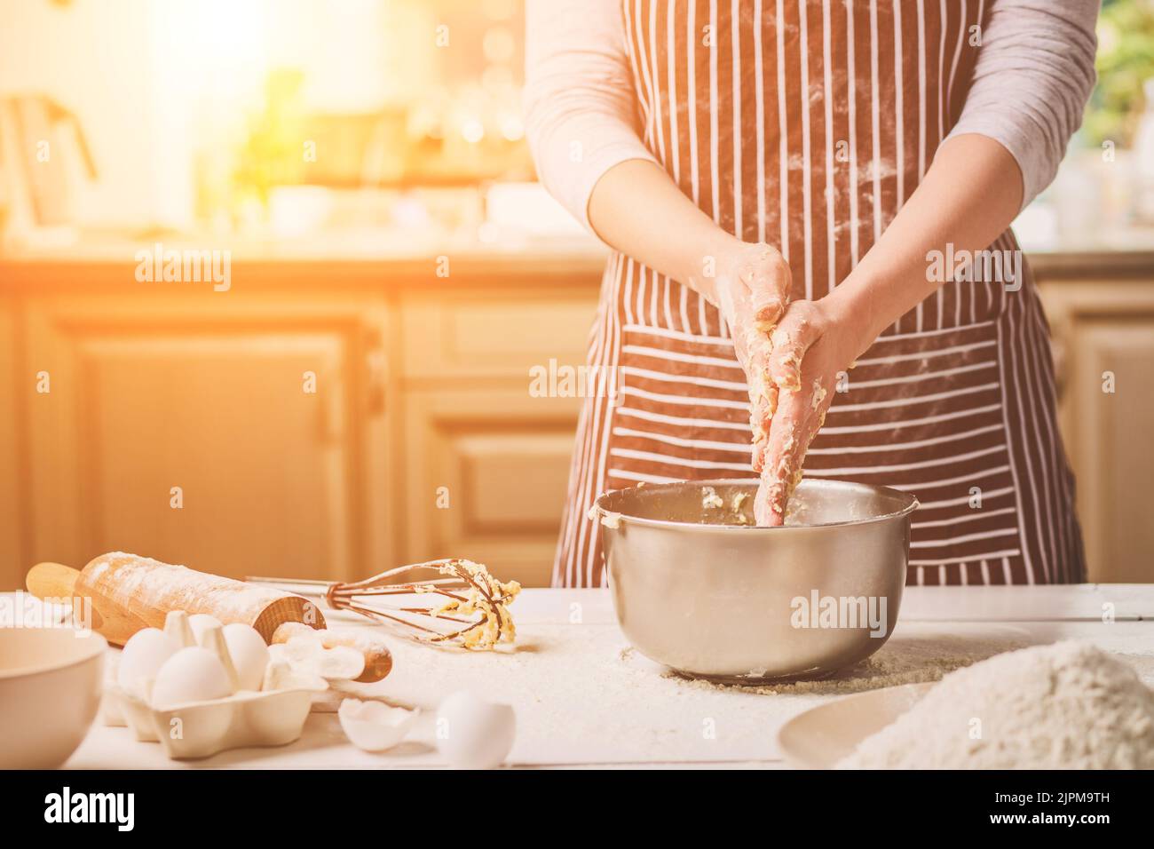 Woman hands kneading dough in iron bowl Stock Photo - Alamy
