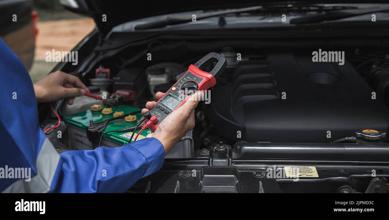 Mechanic checking the car's electrics with a multimeter Stock Photo Alamy