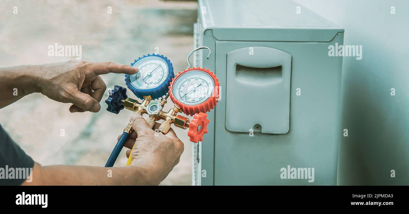 Air conditioner technician checking air conditioner operation Stock Photo Alamy