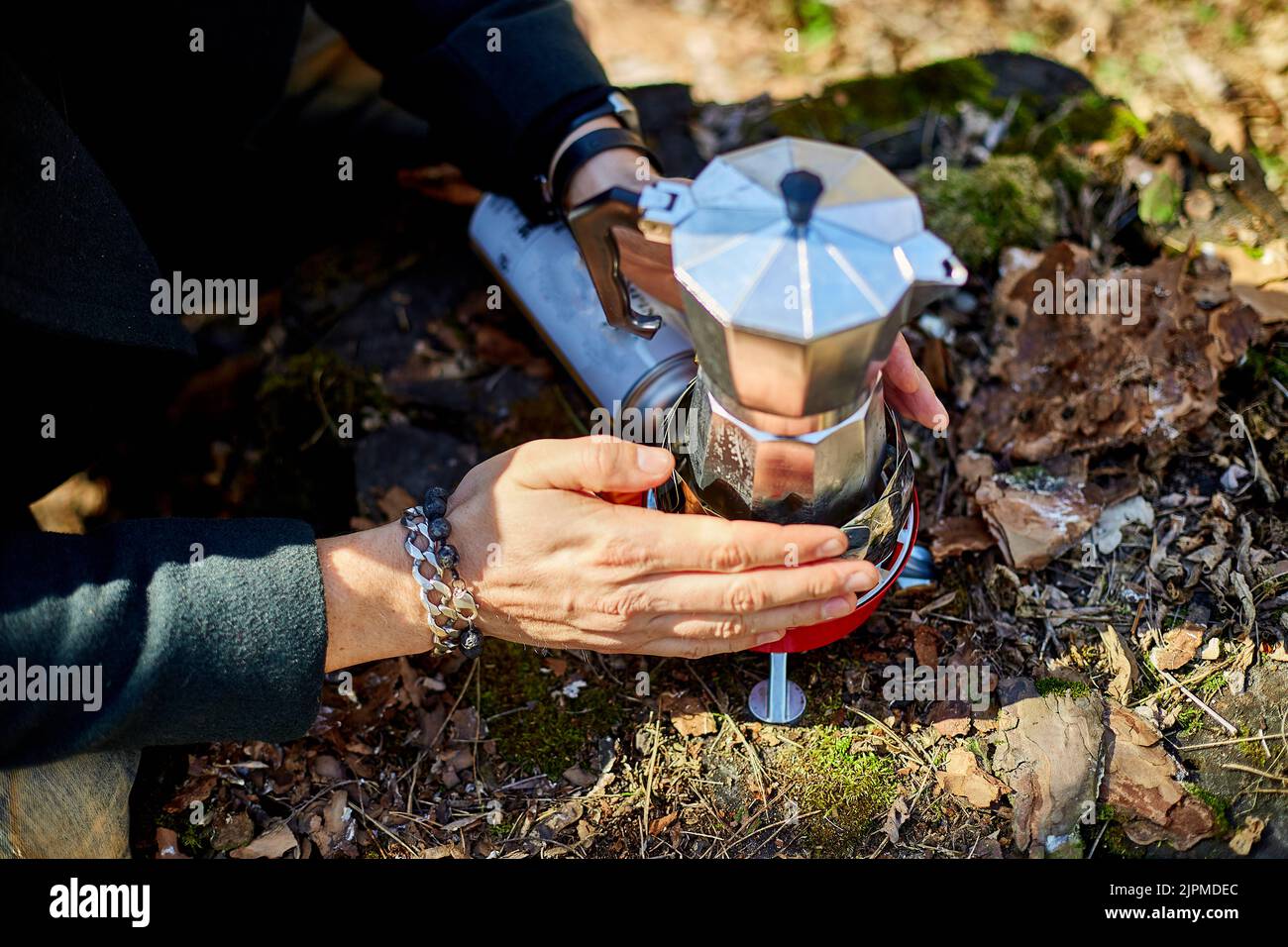 https://c8.alamy.com/comp/2JPMDEC/man-brewing-coffee-from-a-geyser-coffee-maker-on-a-gas-burner-autumn-outdoor-male-prepares-coffee-outdoors-travel-activity-for-relaxing-bushcraft-2JPMDEC.jpg