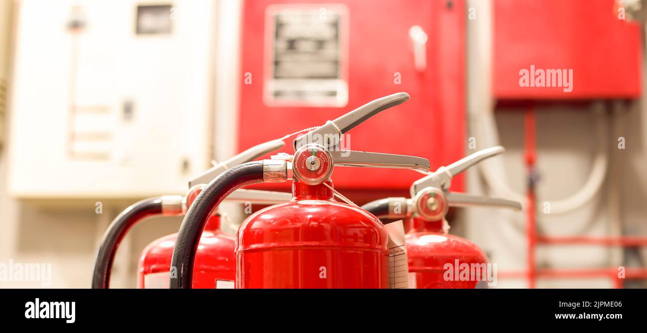 The red fire extinguisher is ready for use in case of an indoor fire