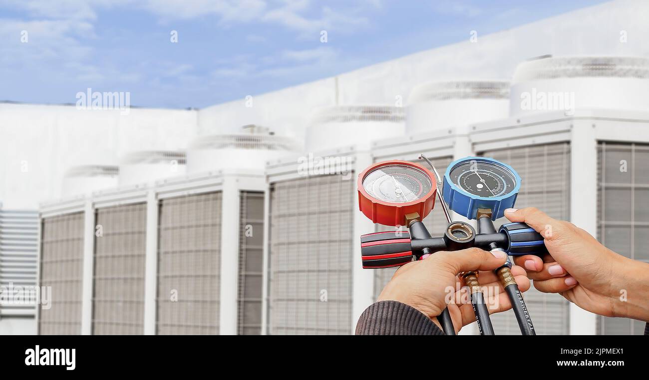 Air conditioner technician checking air conditioner operation Stock
