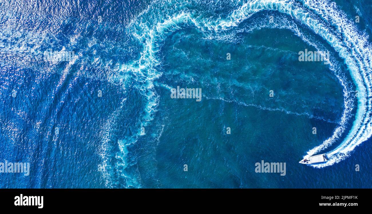 Rest on the water. A speed boat moves in a circle on the surface of the ...