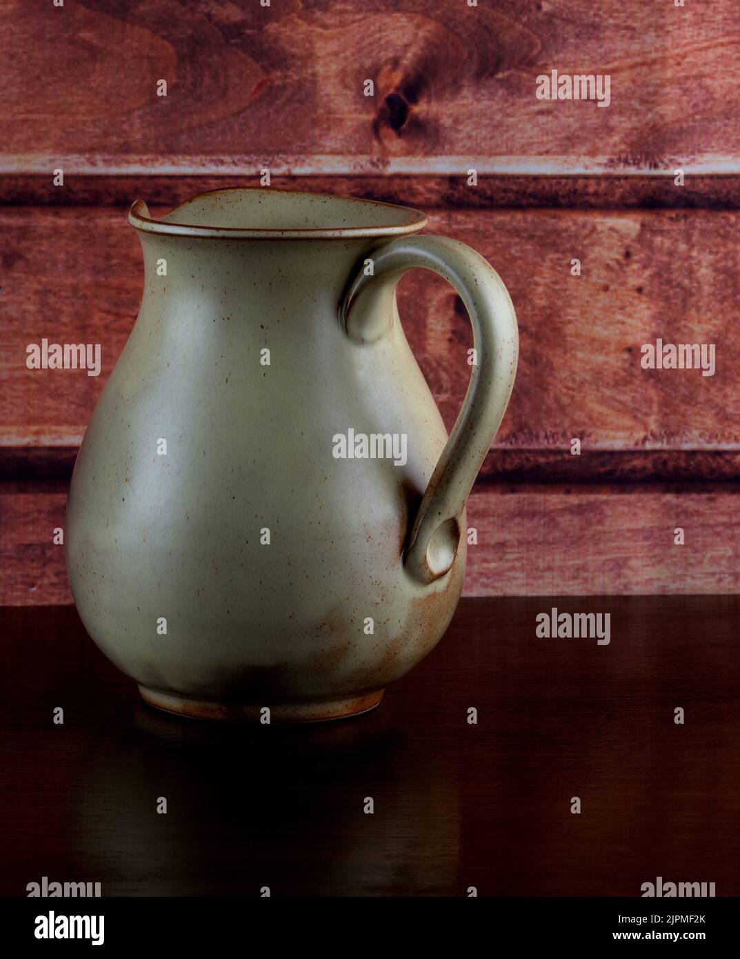 Old earthenware wine jug on a polished wooden shelf Stock Photo Alamy