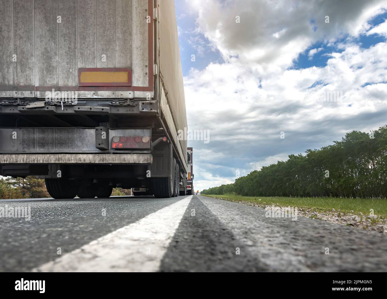Trucks are stuck in traffic. A column of semitrailers on the freeway