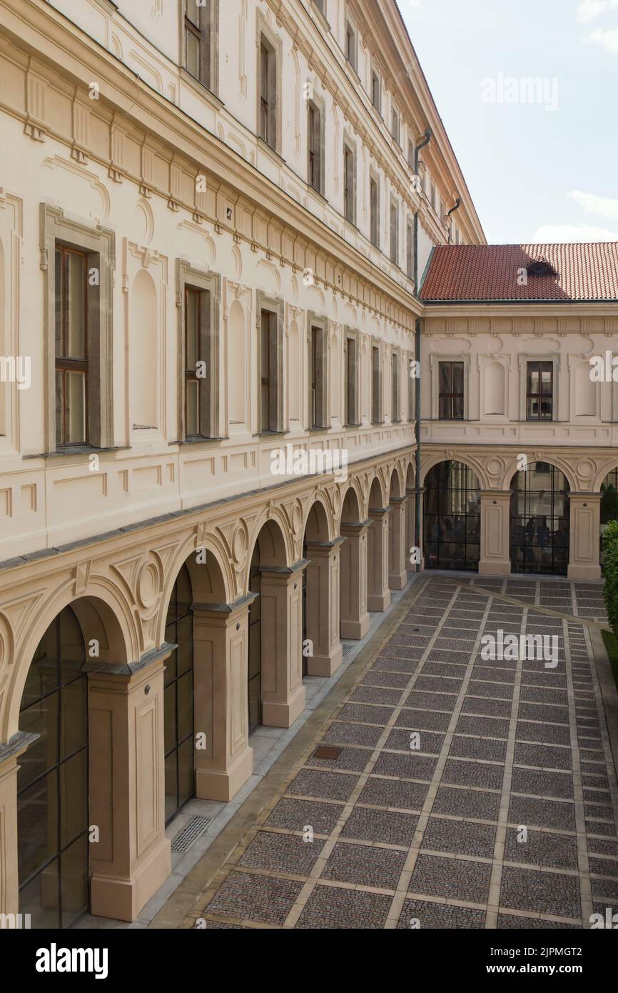 Inner courtyard of the Czernin Palace (Černínský palác) where the body of the Foreign Minister of Czechoslovakia Jan Masaryk was found in Hradčany district in Prague, Czech Republic. The Czernin Palace served as the official residence of the Foreign Minister of Czechoslovakia. On 10 March 1948, Jan Masaryk was found dead under the window of the bathroom of his flat. He probably committed suicide by jumping out of the window or was murdered by the Communist authorities. The black commemorative plaque in the background marks the place where the body was found. Stock Photo