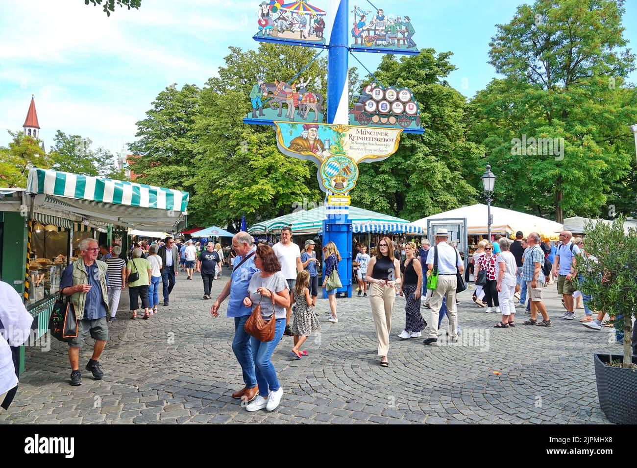 People at the Munich Viktualienmarkt. Munich's most famous permanent food market. Munich, GERMANY - August 2022 Stock Photo