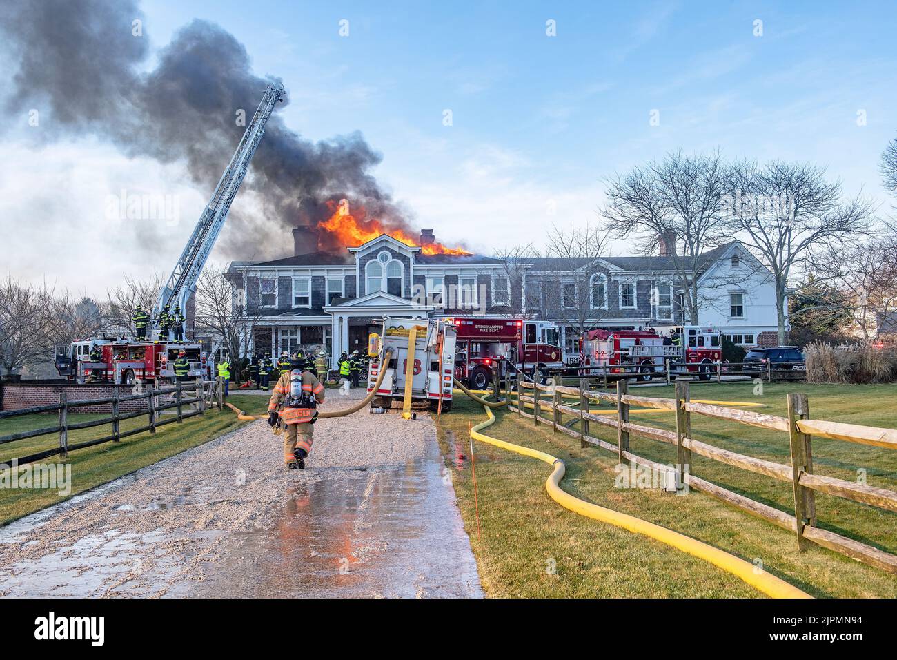 The Bridgehampton Fire Department, assisted by mutual aid from several other local fire departments, battled a working structure fire in the roof of a Stock Photo