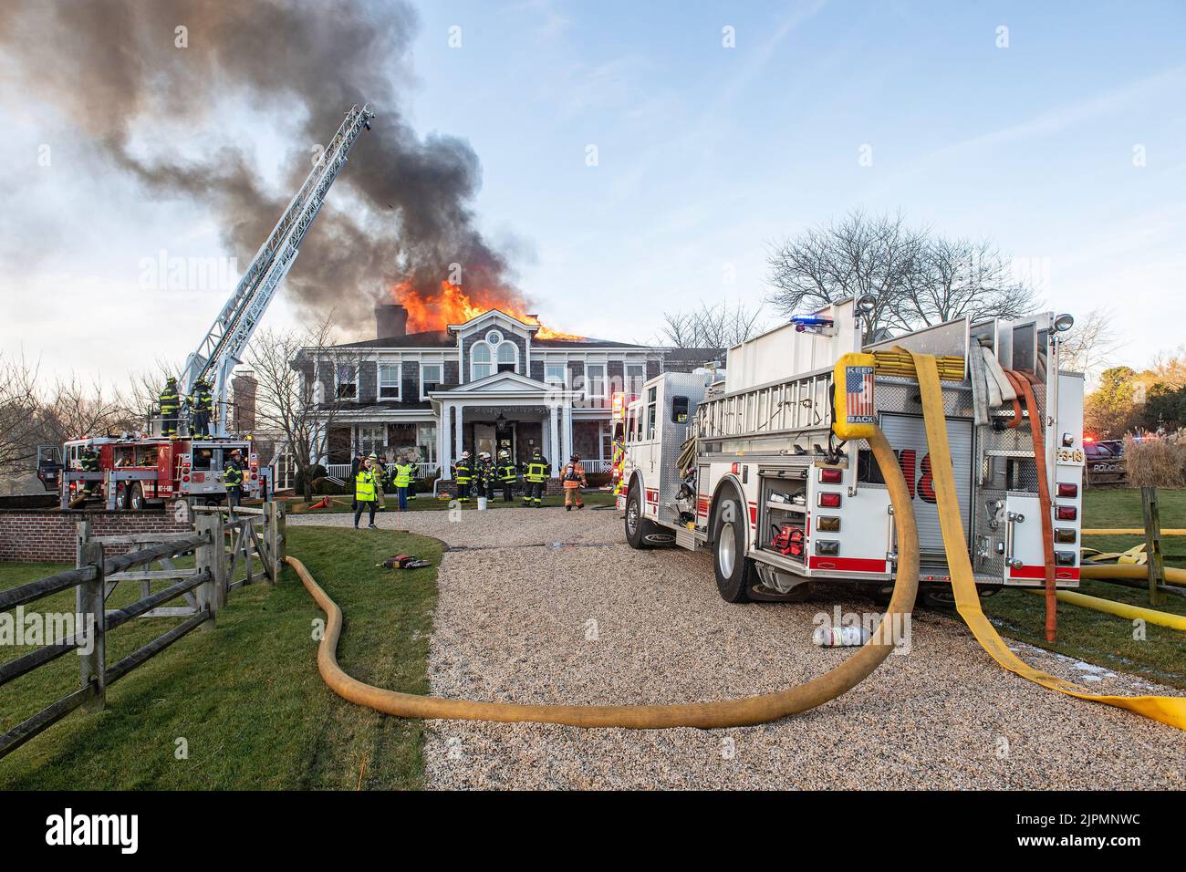 The Bridgehampton Fire Department, assisted by mutual aid from several other local fire departments, battled a working structure fire in the roof of a Stock Photo