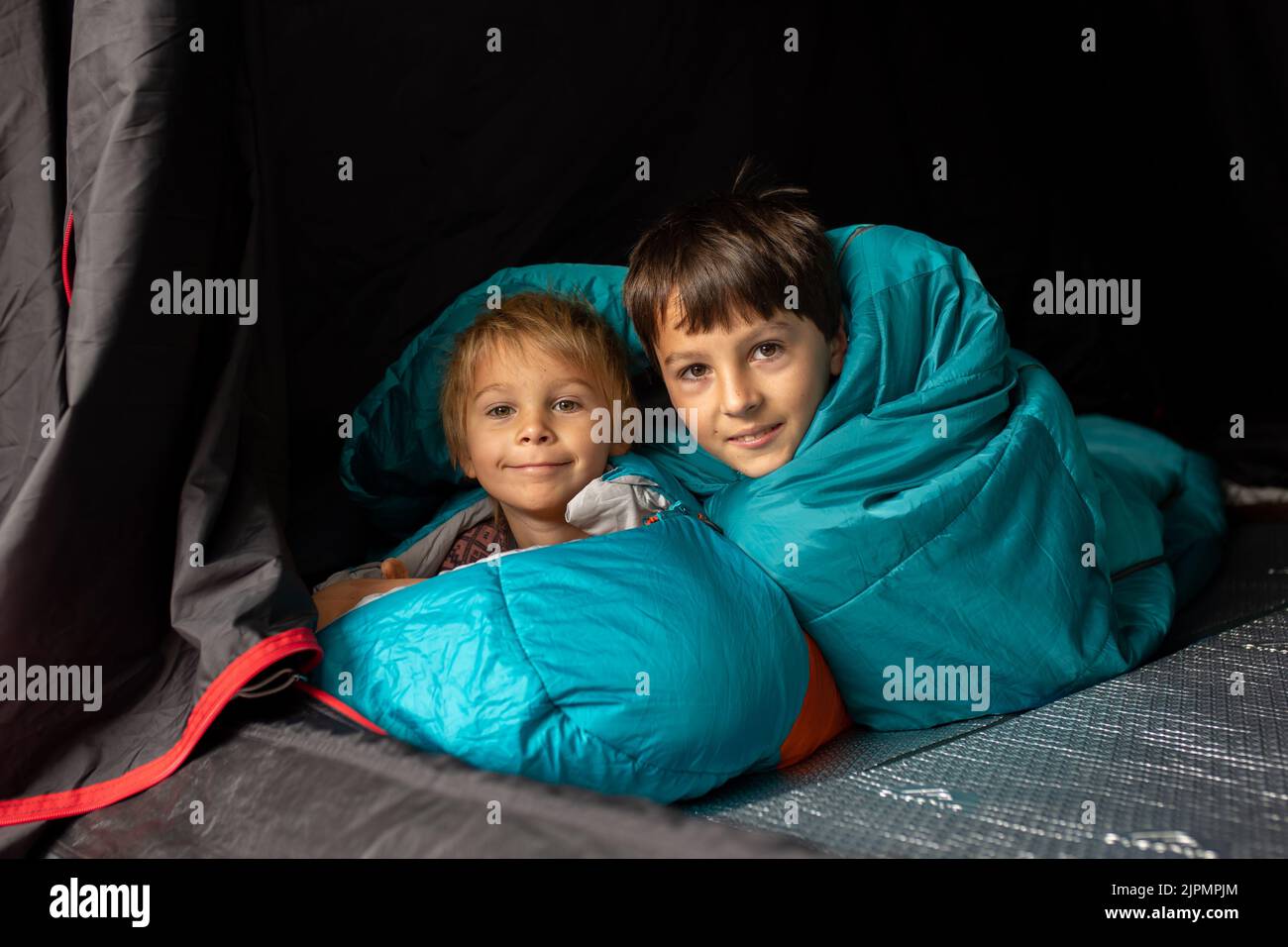 Children, sibilngs, sleeping in sleeping bags in a tent in Norway, wild