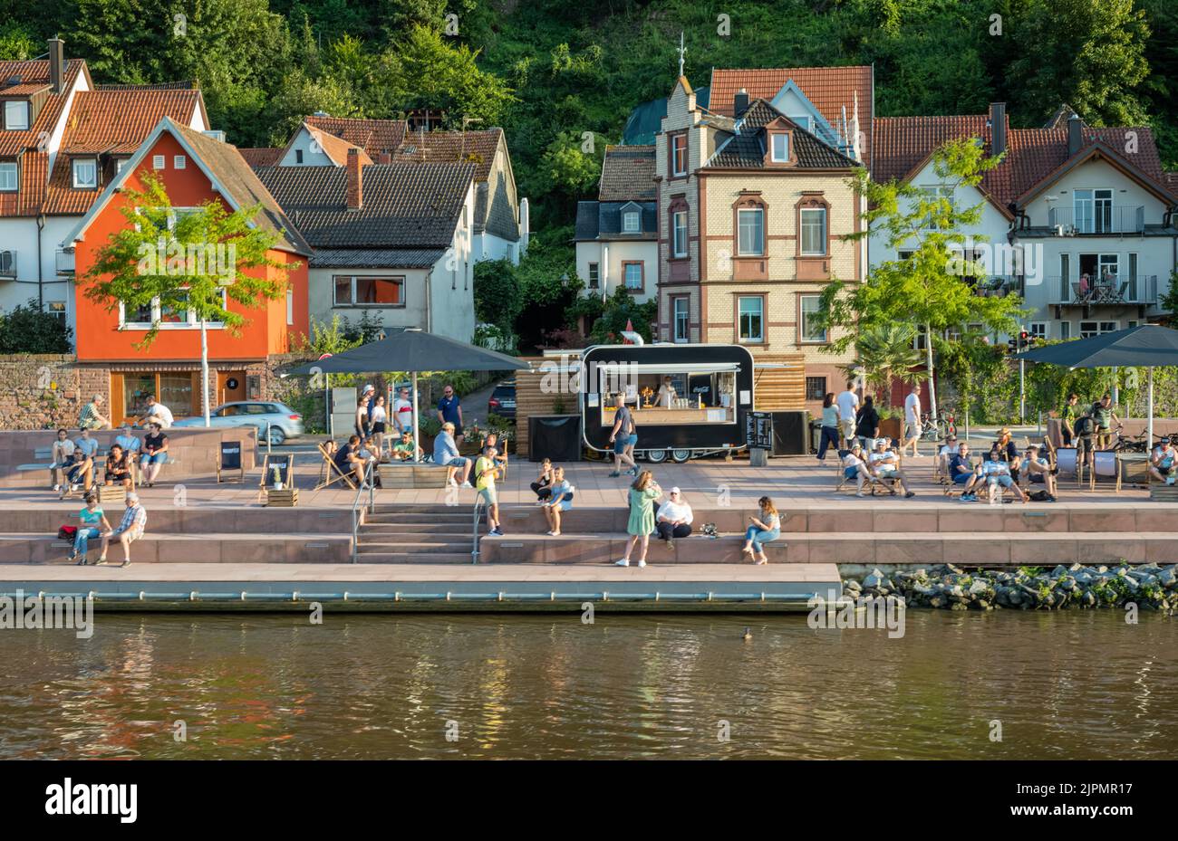 Miltenberg, Germany - July 18, 2021: The old town with people relaxing at the sun,  seen from the River Main Stock Photo