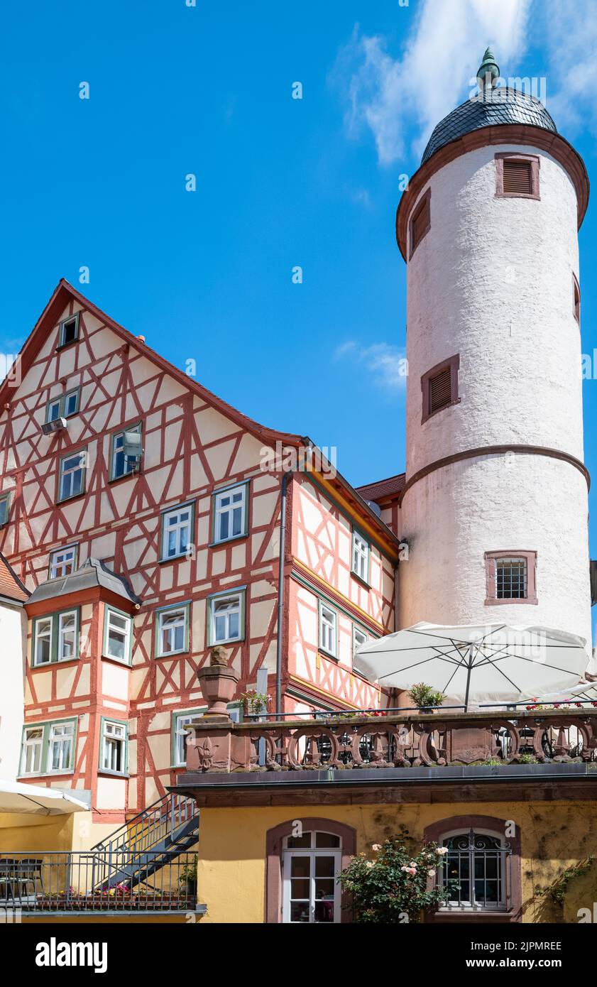 Germany, Wertheim, upwward view of the medieval White Tower and a traditional half-timbered house Stock Photo
