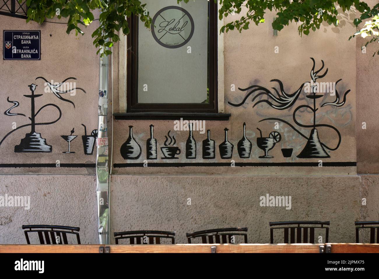 Belgrade-Serbia - June 15, 2022: Detail of  facade wall of shisha bar with graffiti drawing of bottles, drinks, coffee, cocktails, glasses and hookah Stock Photo