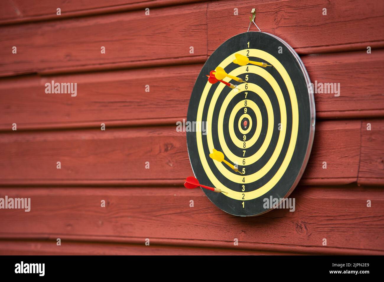 A dart board hanging on a wall Stock Photo Alamy