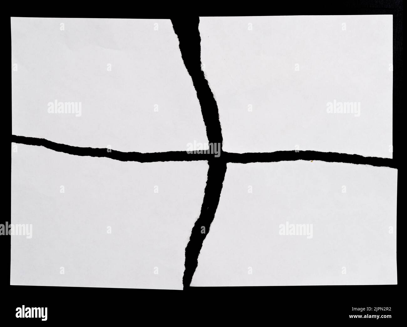 White torn paper on black background Stock Photo