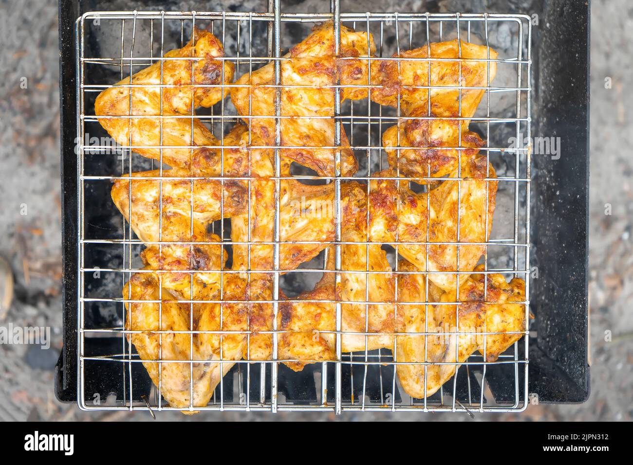 Grilled bird meat on grill. Wings of chicken, turkey, duck. Popular