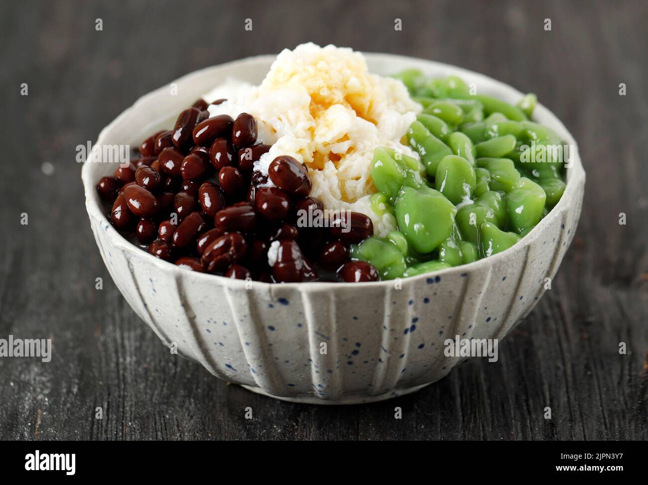 Cendol Malaysian Dessert with Shaved Ice and Red Bean, on Black Wooden Table Stock Photo