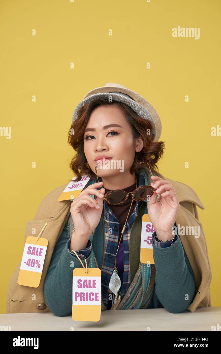 Happy yong Vietnamese woman after buying clothes on sale Stock Photo