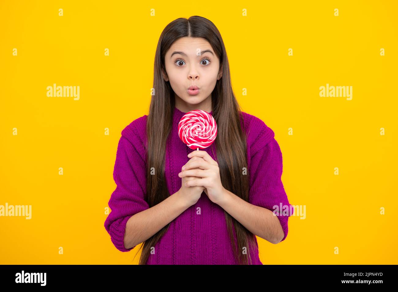 Teenage girl with lollipop, child eating sugar lollipops, kids sweets candy shop. Excited teenager girl. Surprised emotions of young teenager girl. Stock Photo