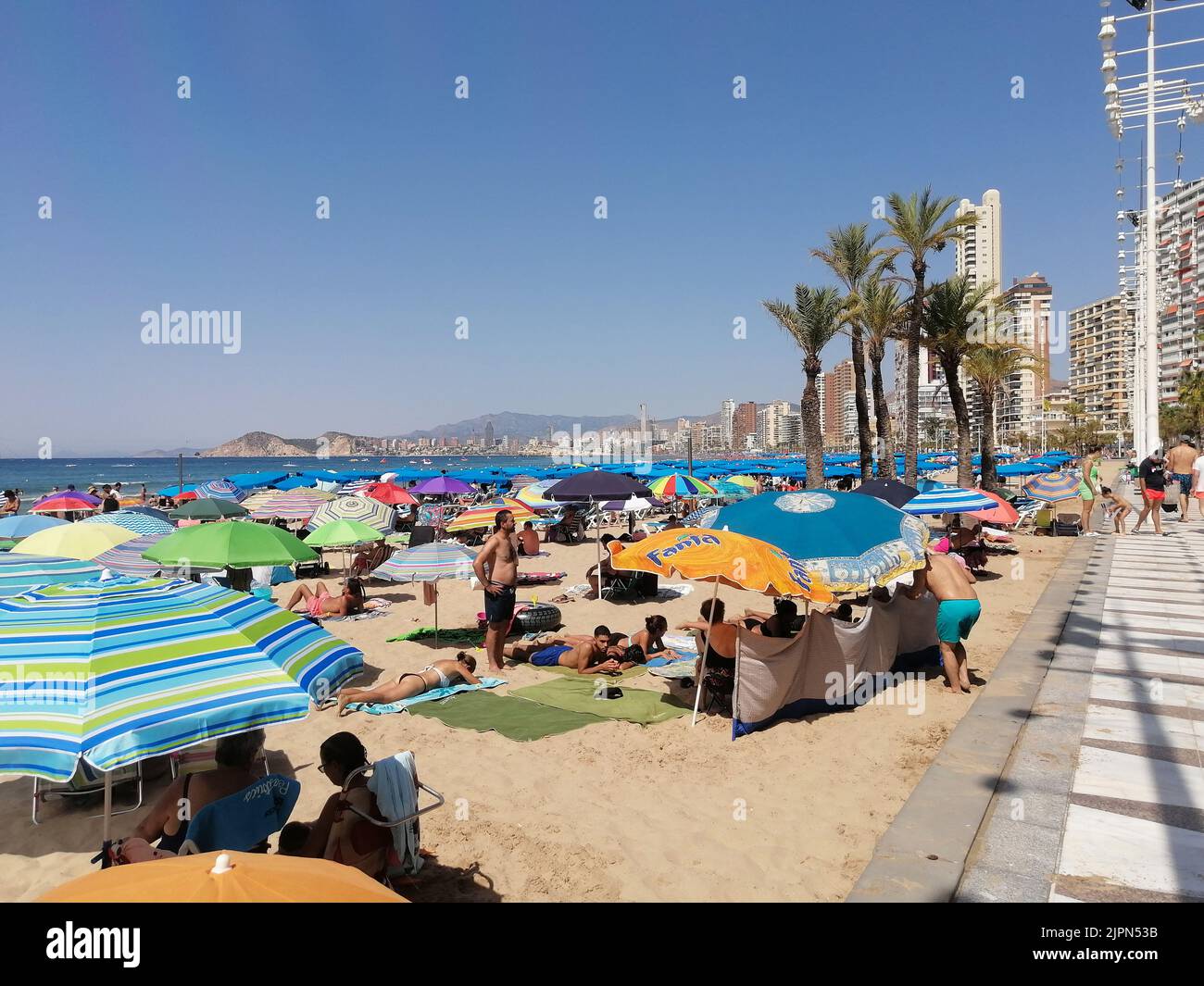 People sunbathing on Levante beach in Benidorm, Alicante Stock Photo