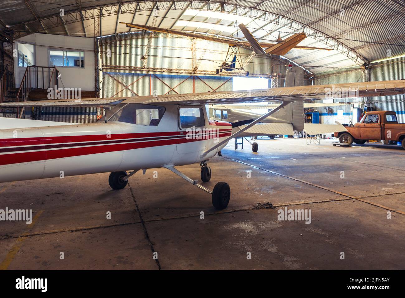 photo of old hangar with airplanes and old truck. Stock Photo