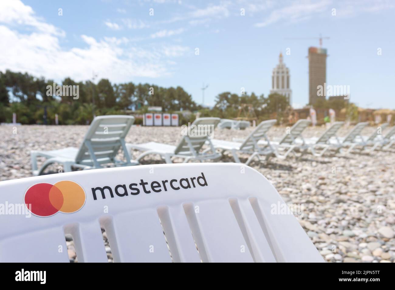 Mastercard logo on a beach bed with copy space. Using credit or debit card to pay for vacation concept. Batumi, Georgia - July 2, 2021 Stock Photo