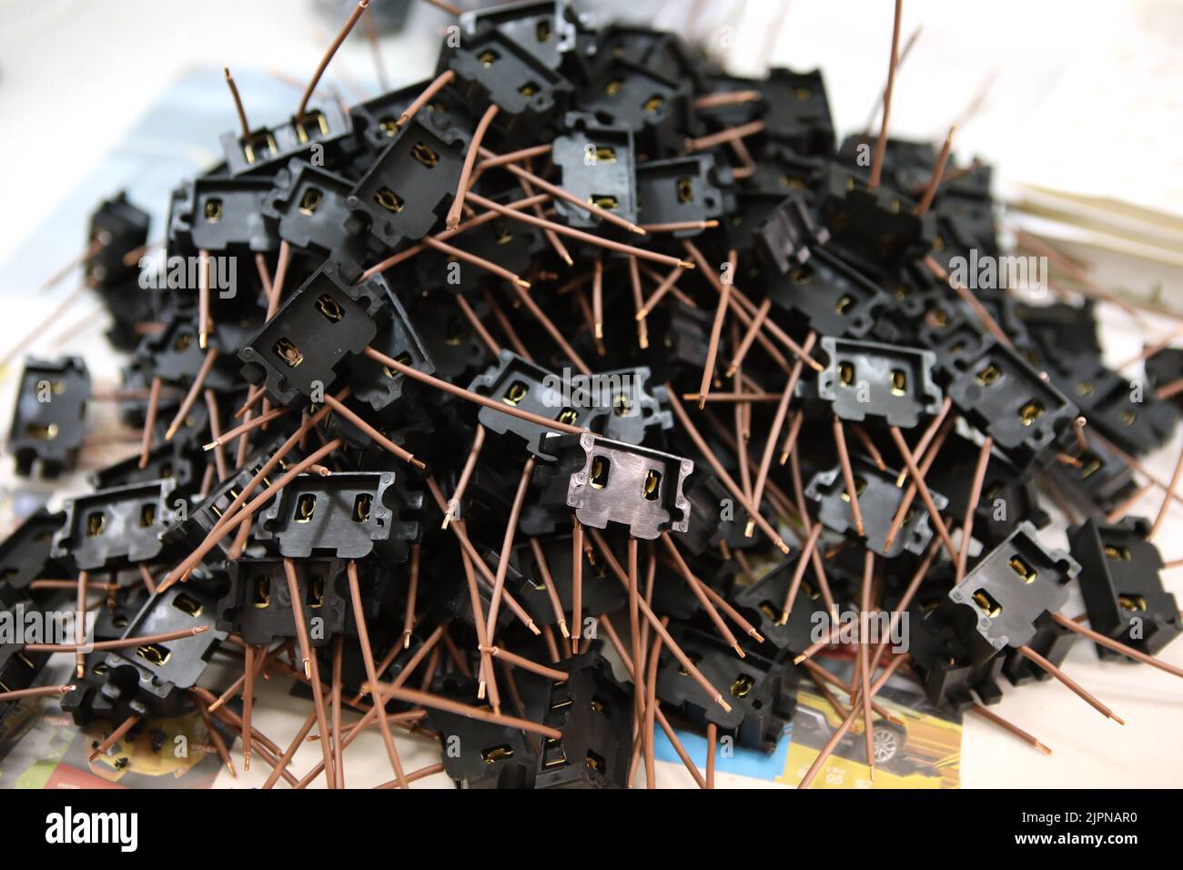 Lots of radios. Loose electronic parts on the table. Digital indicator, LEDs, capacitor and microcircuits in a pile. Stock Photo