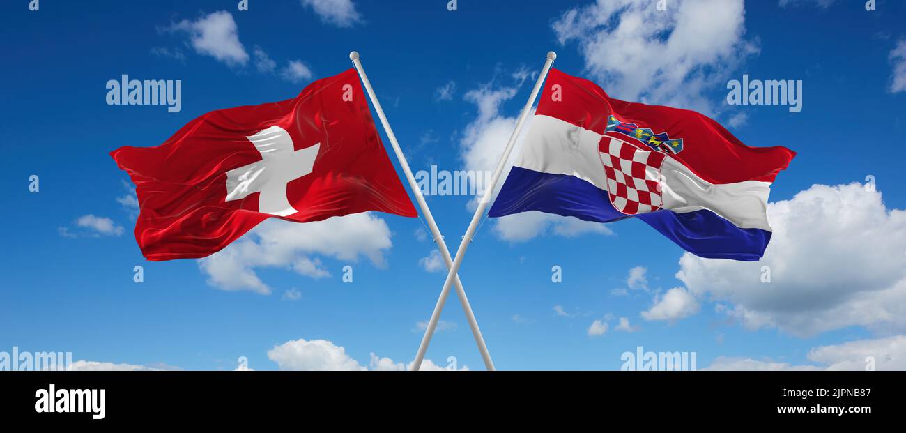 two crossed flags Croatia and Switzerland waving in wind at cloudy sky ...
