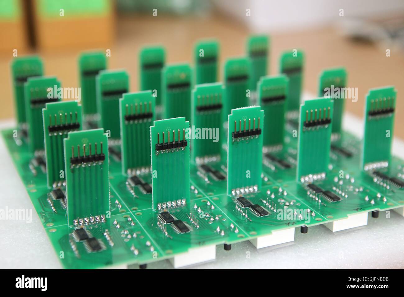 Lots of radios. Loose electronic parts on the table. Digital indicator