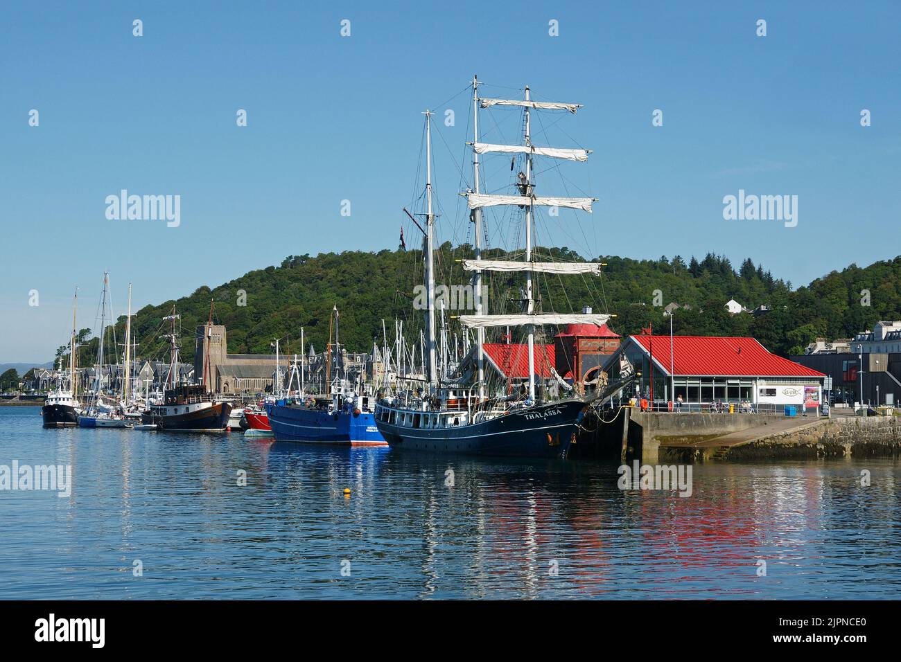 Dutch-registered tall ship Thalassa alongside the North Pier, Oban Harbout, Argyll and Bute, Scotland. Stock Photo