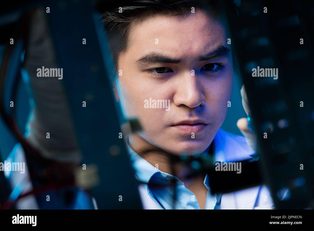 Young Asian electronic engineer working on robotics project Stock Photo