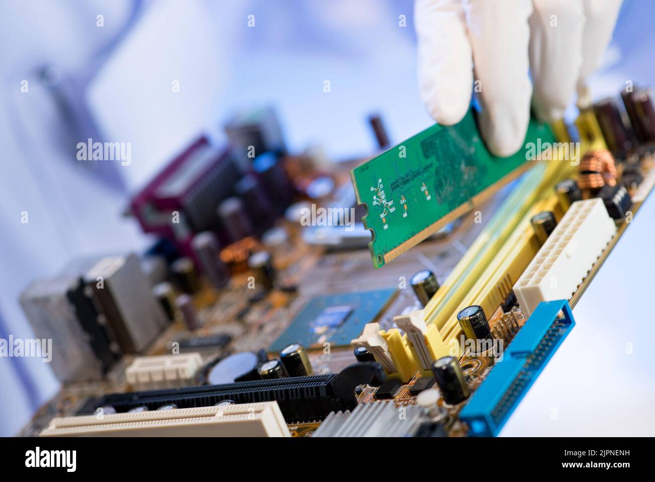 Hand of technicial installing electronic circut board into slot Stock Photo