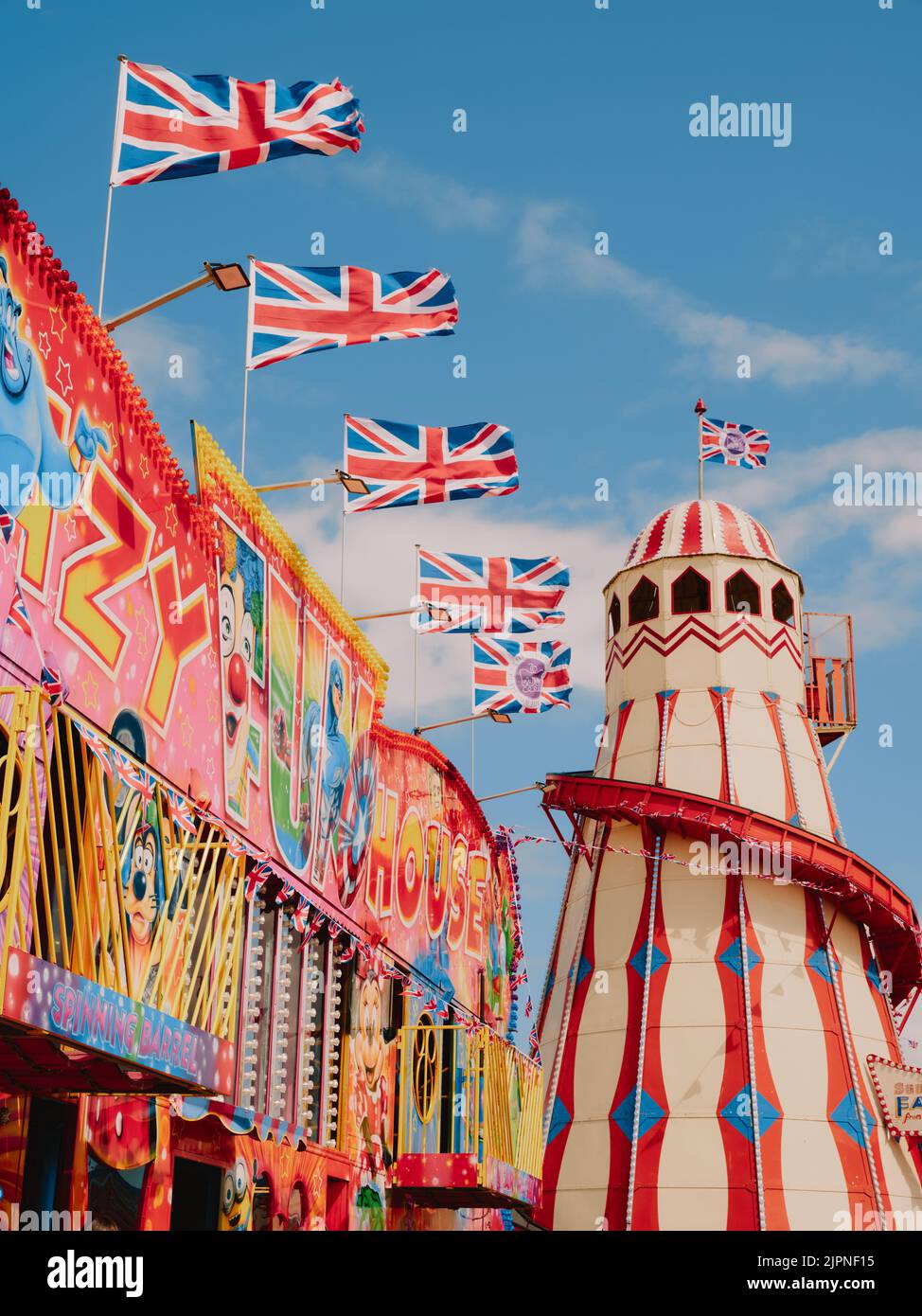 Fun Fair Ride With Flags A colourful summer seaside funfair amusement park / pleasure beach with ...