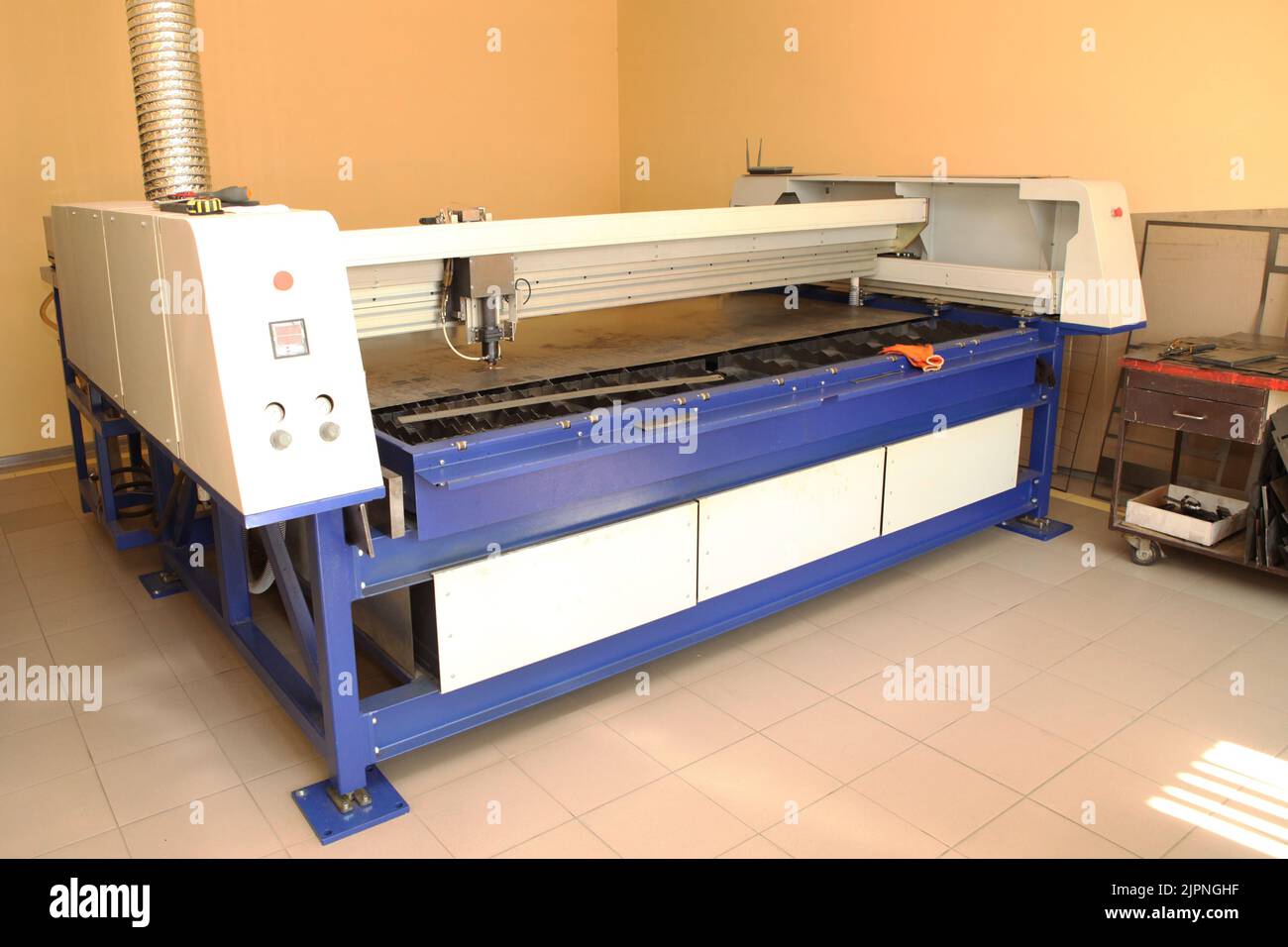 Plasma cutting CNC machine cuts metal material with sparks, industry background aerospace