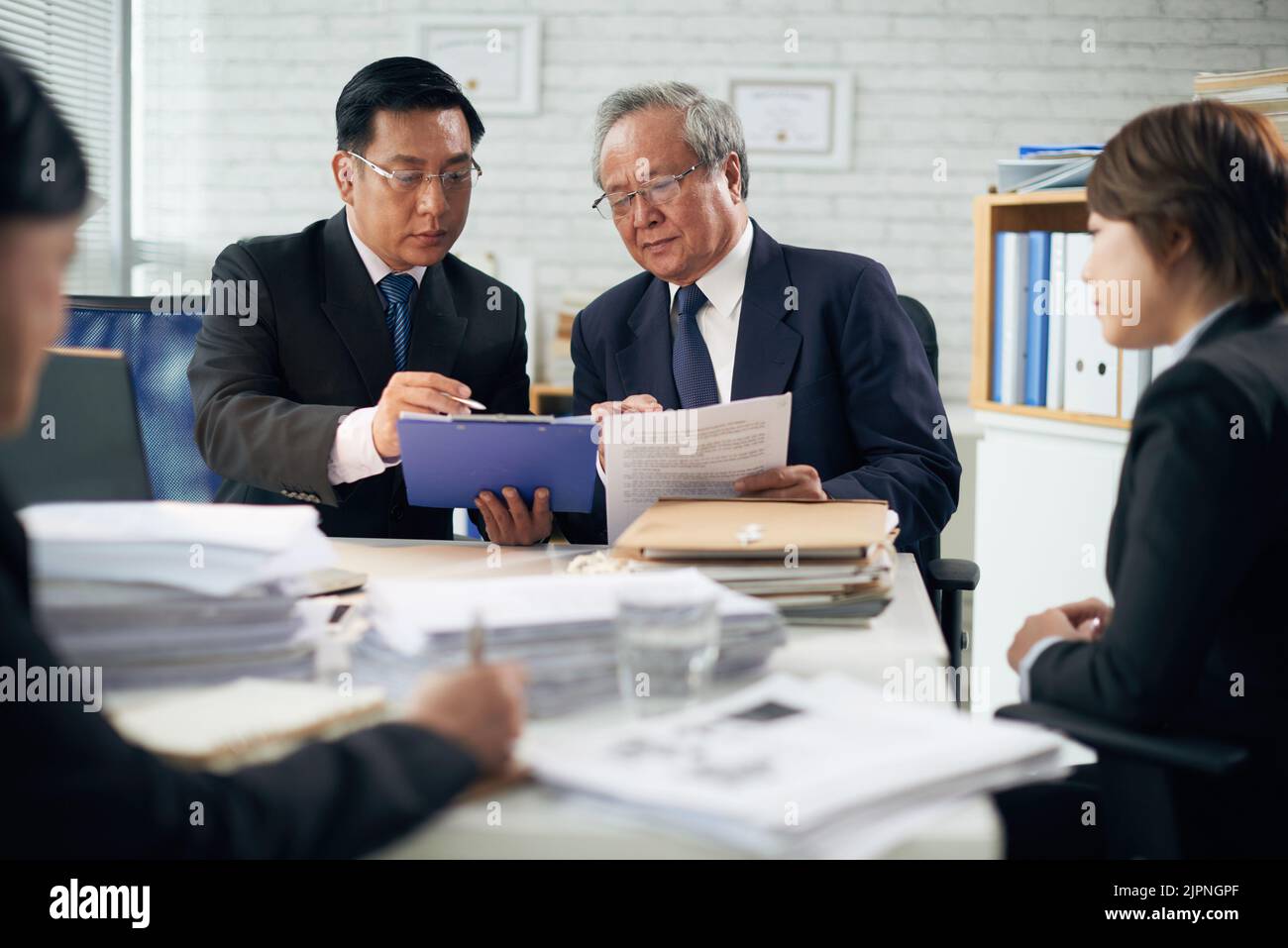 Professional Vietnamese lawyer consulting his coworker Stock Photo Alamy