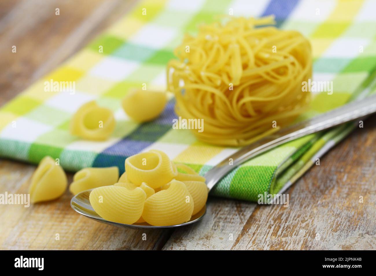 Uncooked pasta on kitchen cloth, closeup Stock Photo