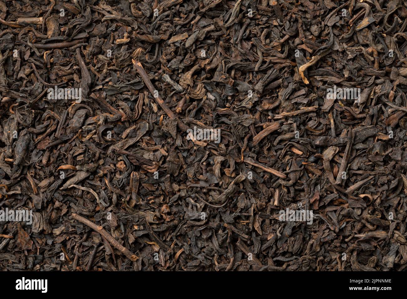 Chinese Pu Ehr dried tea leaves close up full frame as background Stock Photo