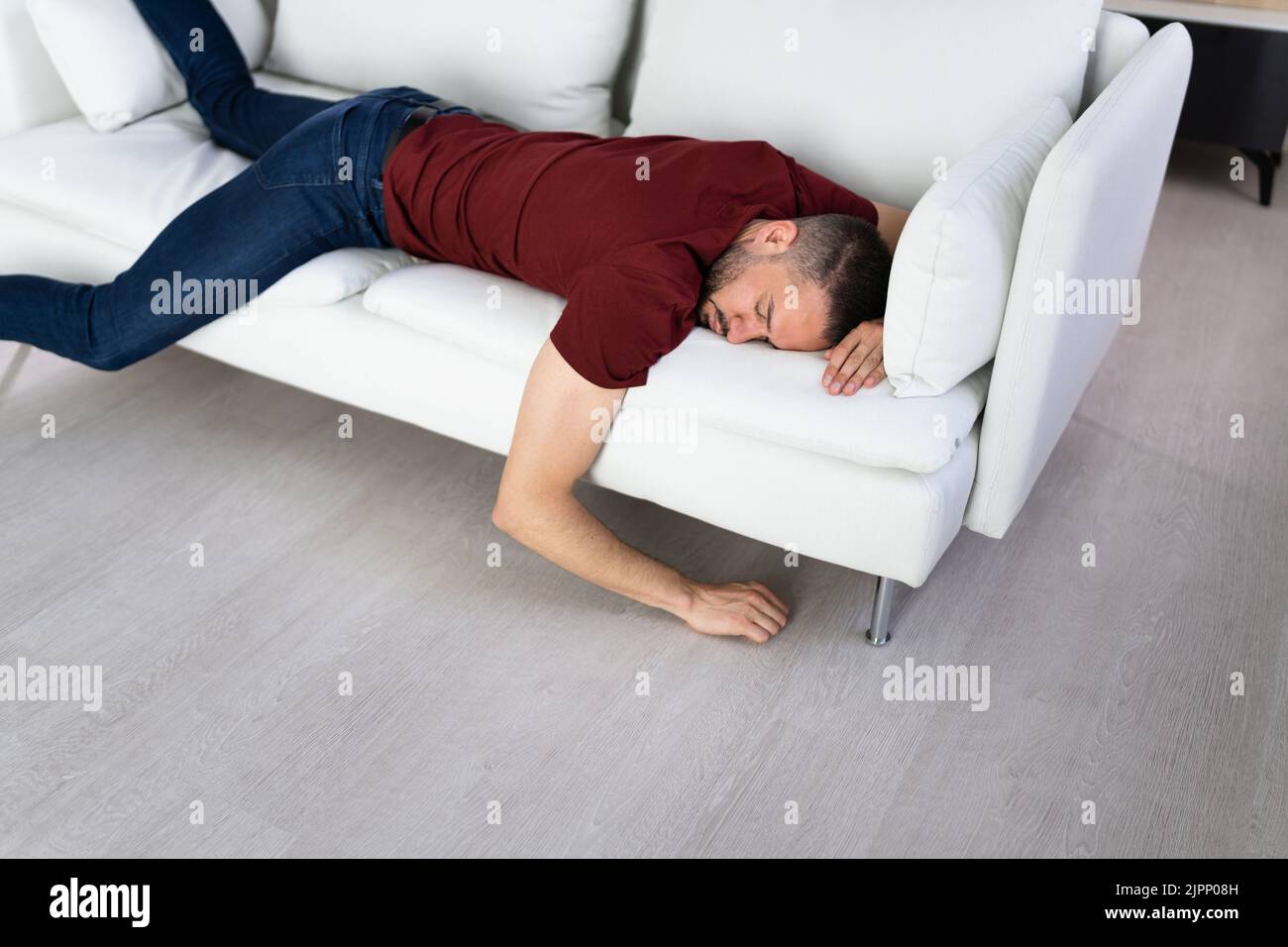 Man With Lethargy And Fatigue On Couch Or Sofa Stock Photo