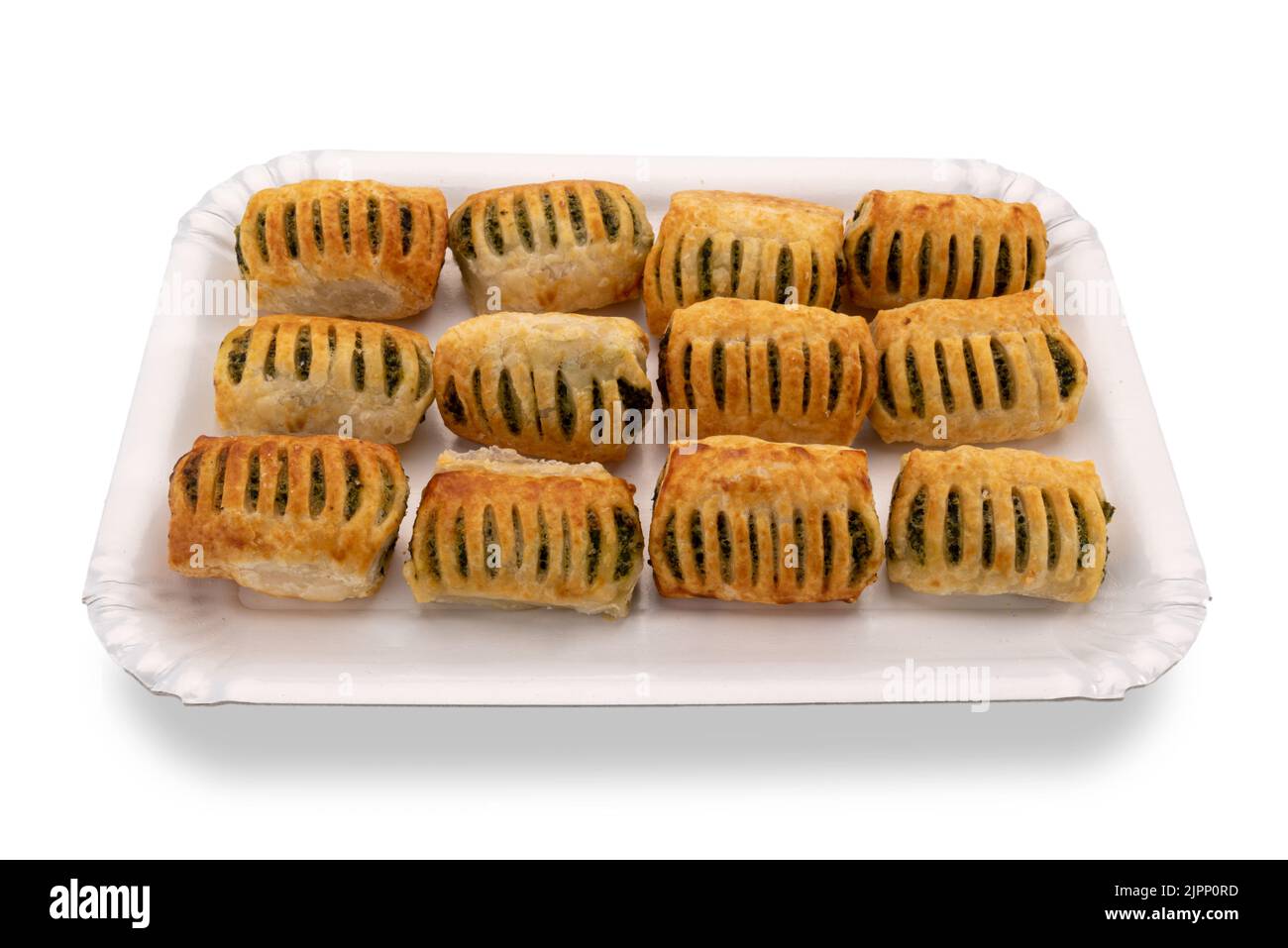 Baked puff pastry stuffed with spinach and cheese on white cardboard